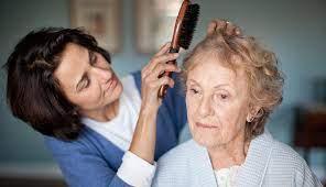 woman brushing and older woman's hair