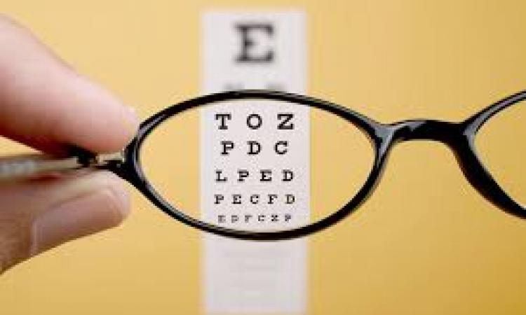 glasses held up to eye chart